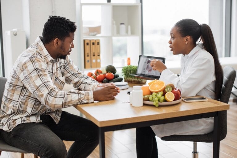 Woman holding tablet with GI tract while counseling client | TMZ Behavioral Care in Davie, FL